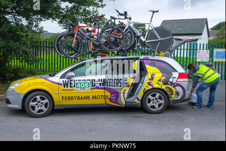bicycle road race support vehicle with spare bikes on the roof rack. Stock Photo