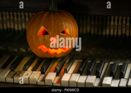Decorations on halloween celebration with pumpkin face and piano as in  witch house Stock Photo