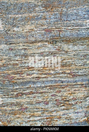 Metamorphic rock surface showing granates and bands of biotite and quartz in Haninge, Stockholm, Sweden. Stock Photo