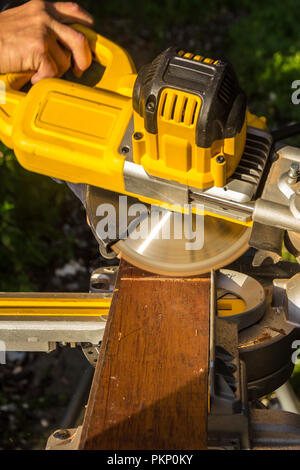 tradesman using electric circular store to cut wood Stock Photo