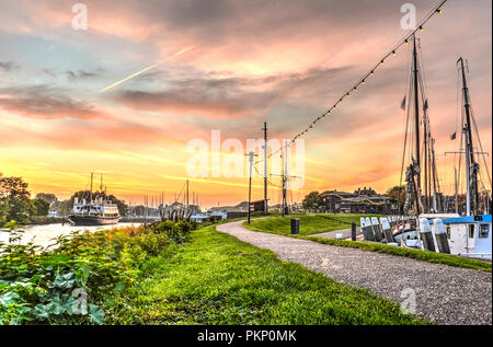 Enkhuizen, The Netherlands, October 26, 2015: Path between Outer Harbour and Ferry Harbour under a spectacular sunset sky Stock Photo