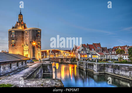 Enkhuizen, The Netherlands, October 26, 2015: Nocturnal view of Dromedaris gate, the drawbridge across the Old Harbour and the traditional houses on t Stock Photo
