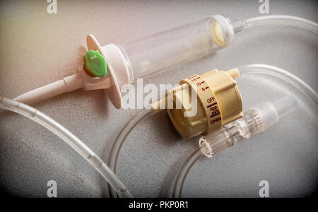 Dial flow next to a syringe at a hospital table, conceptual image Stock Photo