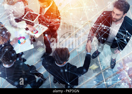 Handshaking business person in office. concept of teamwork and partnership. double exposure with gears system and network effects Stock Photo