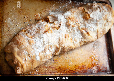 Home made apple strudel just out of the oven still on a baking tray. Stock Photo