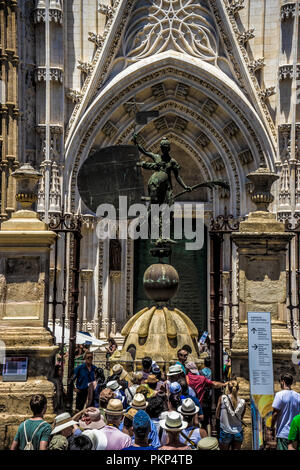 Seville, Spain- June 18, 2017 : Tourists que up near the Triumph of Faith statue to enter the Gothic cathedral in Seville, Spain June 2017, Europe Stock Photo