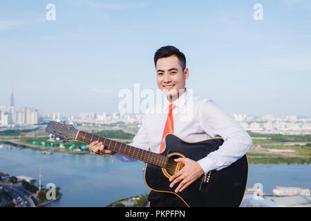 Musical Concept. Casual man playing practicing guitar. Stock Photo