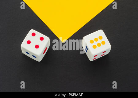 Dice on a black and yellow background Stock Photo