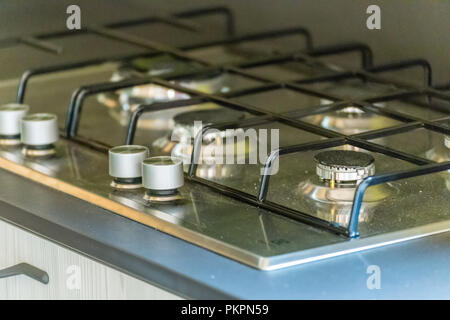 closeup of steel burners and black tray Stock Photo