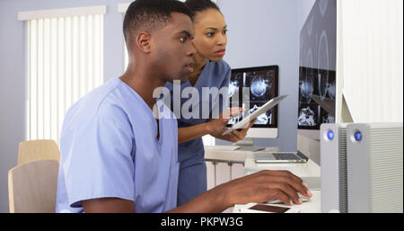 Two Black medical specialists working together at hospital computer Stock Photo