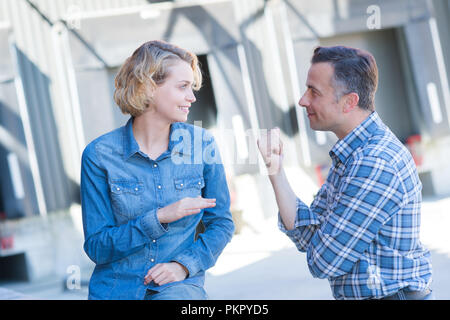 workers talking while walking in shipping yard Stock Photo
