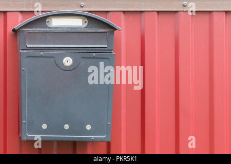 A beautiful mailbox hangs waiting for newspapers, parcels and letters from friends. Stock Photo