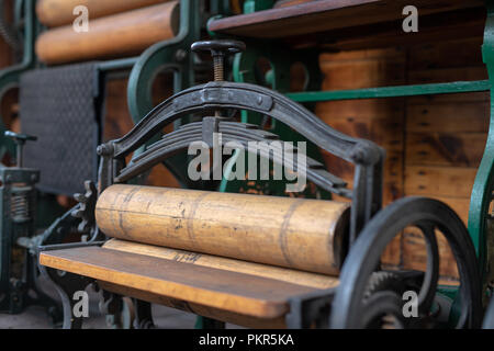 Old mangle for housework. Devices that facilitate housework in an old house. Season of the spring. Stock Photo