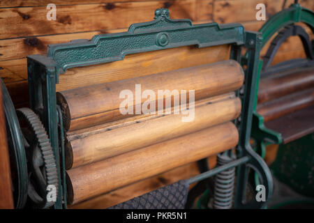 Old mangle for housework. Devices that facilitate housework in an old house. Season of the spring. Stock Photo