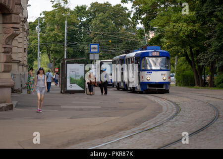 RIGA, LATVIA - JULY 18, 2018: People and public transport moving through the city center streets. Stock Photo