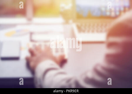 blurred hand pressing on calculator button and alarm clock, business conception Stock Photo