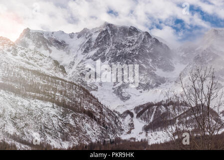 Alps in winter at sunset. Monte Rosa from Macugnaga, north Italy, with the impressive east wall covered with ice Stock Photo