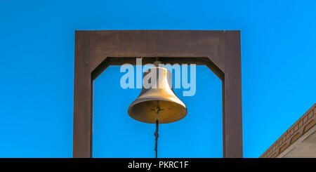 Bell with blue rope attached to a rectangular yoke Stock Photo