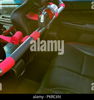 Passenger seat of car with red seat belts Stock Photo