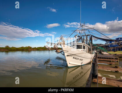 Shrimp boat at pier at Colorado River near its estuary at Gulf of Mexico, near Matagorda, Texas, USA Stock Photo