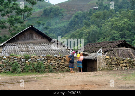 H'Mong ethnic woman in beautiful traditional costume with scene fog in Sa Pa town, Lao Cai province, Vietnam Stock Photo