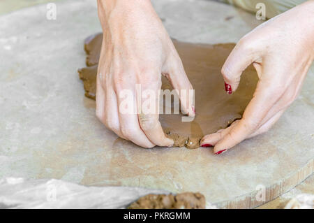 Close up of Caucasian artists hands working on clay in an atelier Stock Photo