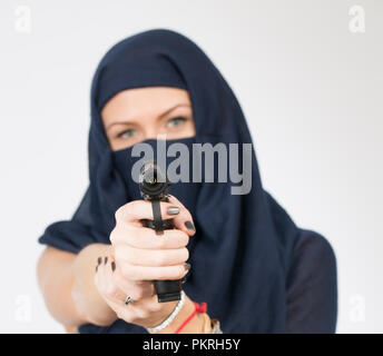 girl in a headscarf with a gun Stock Photo
