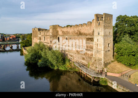 Medieval Gothic castle in Newark on Trent, near Nottingham, Nottinghamshire, England, UK. Aerial view with Trent River and a bridge in sunset light Stock Photo