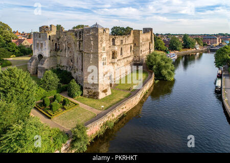 Medieval Gothic castle in Newark on Trent, near Nottingham, Nottinghamshire, England, UK. Aerial view with Trent River in sunset light Stock Photo