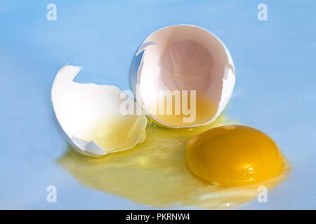 Eggs in carton with some broken.  Some images eggs frying on hot asphalt, concept. Stock Photo