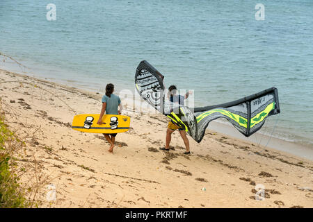 Tourists Kitesurfing on the waves of the sea the beach on a sunny day at Ninh Chu beach in Vietnam Stock Photo