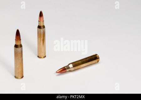 A white background and three 223 cartridges Stock Photo