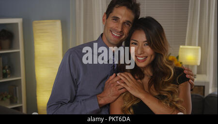 Happy interracial couple smiling at camera Stock Photo