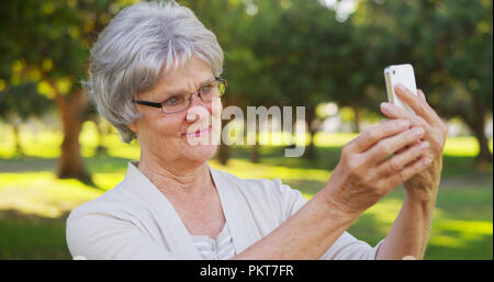 Hip grandma taking selfies at the park Stock Photo - Alamy