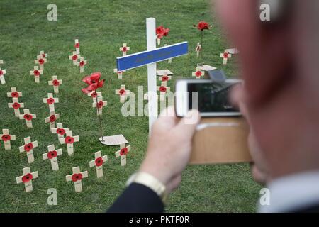 Worcester, Worcestershire, UK. 15th September 2018. An ex-serviceman takes a photograph on his mobile phone of memorial crosses at the Drumhead Service at Gheluvelt Park, Worcester. Peter Lopeman/Alamy Live News Stock Photo