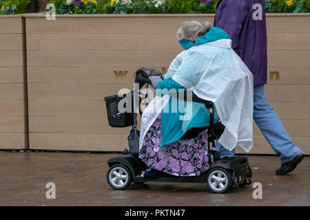Woman in powered scooter in Blackpool, Lancashire. 15th Sep 2018. UK Weather. Sunshine & showers as holiday makers enjoy the attractions of the seaside resort.   Credit:MedialWorldLmages/AlamyLiveNews Stock Photo