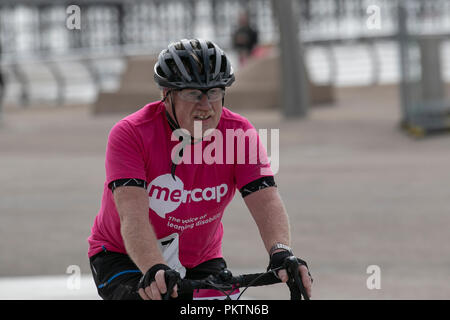 Blackpool, Lancashire, UK. 15th Sep 2018. 'Pedal to the Pier' Mencap Off road Cycling 100km Challenge. Mud spattered Competitor approaches the finish line after a gruelling 60 mile charity off-road cycle ride from Manchester to Blackpool, terminating at the Tower Headland. Credit; MediaWorldImages/AlamyLiveNewsMencap Off road Cycling 100km Challenge. Mud spattered Competitor approaches the finish line after a gruelling 60 mile charity off-road cycle ride from Manchester to Blackpool, terminating at the Tower Headland. Credit; MediaWorldImages/AlamyLiveNews Stock Photo