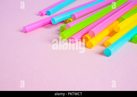 Multicoloured Plastic Drinking Straws on Pink Background Stock Photo