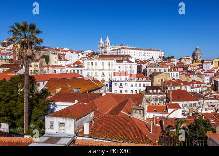 Sao Vicente de Fora Monastery and Alfama District orange rooftops seen from Miradouro das Portas do Sol viewpoint. Lisbon, Portugal. Stock Photo