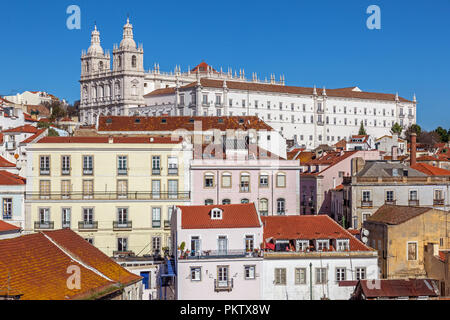 Sao Vicente de Fora Monastery and Alfama District orange rooftops seen from Miradouro das Portas do Sol viewpoint. Lisbon, Portugal. Stock Photo