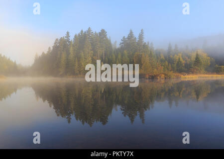 Morning fog, water reflection in the lake, Lac Lajoie, Mont Tremblant National Park, Quebec Province, Canada Stock Photo