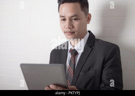 Close up shot Asian businessman using tablet computer for business technology concept Stock Photo