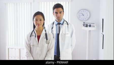 Happy doctors standing in office Stock Photo