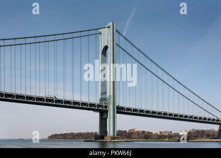 04-2018 New York, USA. Verrazano-Narrows Bridge over New York Harbor. Circa-1964 suspension bridge featuring 693-ft.-tall towers & linking Brooklyn & Stock Photo