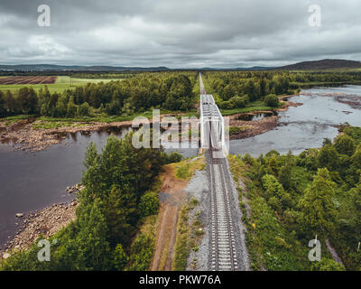 Steel railroad bridge over river in northern Finland seen from the air Stock Photo
