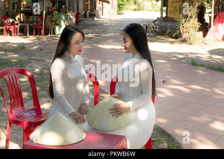 Two Vietnamese girls are gentle in culture traditional white long dress