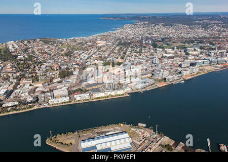 Aerial view of Newcastle harbour and city looking south towards the residential surburbs of Merewether and Bar Beach. Newcastle CBD in the foreground. Stock Photo