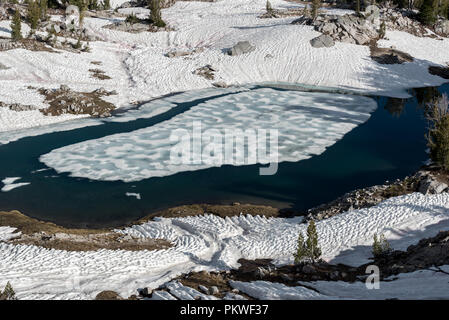 Ice floating on a sub-alpine lake in early summer, Wallowa Mountains, Oregon. Stock Photo