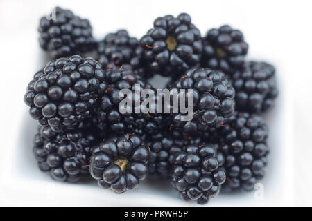 Background from fresh Blackberries, close up. Lot of ripe juicy wild fruit raw berries lying on the table. Top view, Flat lay Stock Photo