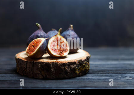 sliced fig fruits on a wooden board Stock Photo